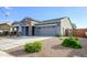 Gray house with stone accents, two-car garage, and well-maintained landscaping at 7917 W Sierra Vista Dr, Glendale, AZ 85303