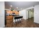 Modern kitchen with island, stainless steel appliances, and dark wood flooring at 7917 W Sierra Vista Dr, Glendale, AZ 85303