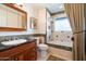 Stylish bathroom featuring stone countertops, a walk-in shower and a bathtub for relaxation at 8031 N 14Th Ave, Phoenix, AZ 85021