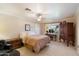 Bright bedroom featuring a ceiling fan, a window and a classic wardrobe adjacent to a desk at 8031 N 14Th Ave, Phoenix, AZ 85021