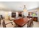 Spacious dining room featuring neutral carpet, large windows, and a traditional-style wooden table at 8031 N 14Th Ave, Phoenix, AZ 85021