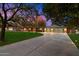 Spacious home featuring a long driveway and three-car garage set against a dramatic dusk sky at 8031 N 14Th Ave, Phoenix, AZ 85021