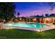 A beautiful in-ground pool is surrounded by a lush, green lawn at 8031 N 14Th Ave, Phoenix, AZ 85021