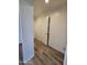 Clean hallway with wood-look floors and an interior door at 813 S Doran Cir, Mesa, AZ 85204