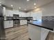 Modern kitchen with white cabinets, stainless steel appliances, and dark countertops at 813 S Doran Cir, Mesa, AZ 85204