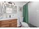 Modern bathroom with updated vanity and green shower curtain at 8241 N Central Ave # 13, Phoenix, AZ 85020