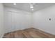 Simple bedroom with light walls, wood floors and double door closet at 8241 N Central Ave # 13, Phoenix, AZ 85020