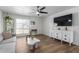 Living room with gray sofa, white TV stand and wood floors at 8241 N Central Ave # 13, Phoenix, AZ 85020