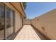 Private tiled patio with block wall and partial view of landscaping at 8241 N Central Ave # 13, Phoenix, AZ 85020