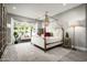 Elegant bedroom with a four-poster bed and large windows at 9016 N 60Th St, Paradise Valley, AZ 85253