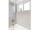 Shower stall with tile surround and window at 908 E Cavalier Dr, Phoenix, AZ 85014