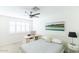 Bright bedroom featuring a ceiling fan, built-in desk and large windows at 908 E Cavalier Dr, Phoenix, AZ 85014