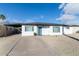 Remodeled mid-century home with carport, and a teal front door at 908 E Cavalier Dr, Phoenix, AZ 85014