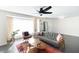 Living room with gray couch and ceiling fan at 908 E Cavalier Dr, Phoenix, AZ 85014