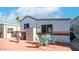 Mobile home with patio furniture and storage shed at 916 Mineshaft Dr # 916, Apache Junction, AZ 85119