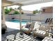 Inviting backyard with sparkling pool, patio furniture, and pergola at 9207 W Highland Ave, Phoenix, AZ 85037