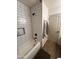 Clean bathroom with white subway tiles, tub, and modern fixtures at 9207 W Highland Ave, Phoenix, AZ 85037