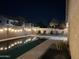 Night view of a backyard pool with string lights and seating at 9207 W Highland Ave, Phoenix, AZ 85037