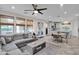 Open living area with gray sectional sofa and adjacent dining area at 9236 E Canyon View Rd, Scottsdale, AZ 85255