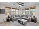 Living room with gray sectional sofa and large windows at 9236 E Canyon View Rd, Scottsdale, AZ 85255