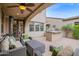 Covered patio features a seating area and outdoor kitchen at 9236 E Canyon View Rd, Scottsdale, AZ 85255