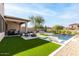 Resort-style backyard with a pool, patio, and lush landscaping at 10018 E Hillside Dr, Scottsdale, AZ 85255