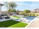 Spacious backyard oasis with a pool, artificial turf, and seating area at 10018 E Hillside Dr, Scottsdale, AZ 85255