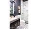 Bathroom features marble shower, dark vanity, and geometric floor tiles at 10018 E Hillside Dr, Scottsdale, AZ 85255