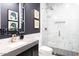 Elegant bathroom with marble shower, dark vanity, and hexagon floor tiles at 10018 E Hillside Dr, Scottsdale, AZ 85255