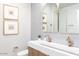 Elegant bathroom with a double vanity, gold accents, and gray tile at 10018 E Hillside Dr, Scottsdale, AZ 85255