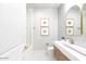 Modern bathroom with gray tile, gold fixtures, and a floating vanity at 10018 E Hillside Dr, Scottsdale, AZ 85255