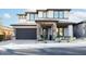 Two-story home with stone accents, a three-car garage, and desert landscaping at 10018 E Hillside Dr, Scottsdale, AZ 85255