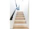 Modern light-wood staircase with black railings at 10018 E Hillside Dr, Scottsdale, AZ 85255