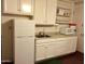 Small basement kitchenette with white cabinets at 1041 E 9Th Dr, Mesa, AZ 85204