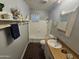 Clean bathroom with a tub, toilet and wood vanity at 1041 E 9Th Dr, Mesa, AZ 85204