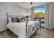 Bedroom with mountain views and iron bed frame at 10452 E Quartz Rock Rd, Scottsdale, AZ 85255