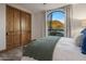 Bedroom with mountain view and wood doors at 10452 E Quartz Rock Rd, Scottsdale, AZ 85255