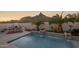 Stunning pool with waterfall and mountain views at sunset at 10452 E Quartz Rock Rd, Scottsdale, AZ 85255