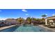 Resort-style pool with a waterfall, mountain views, and comfortable seating at 10452 E Quartz Rock Rd, Scottsdale, AZ 85255