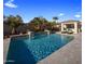 Stunning rectangular pool with waterfall feature and ample deck space at 10452 E Quartz Rock Rd, Scottsdale, AZ 85255