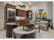 Elegant wine cellar with custom cabinetry and seating area at 10452 E Quartz Rock Rd, Scottsdale, AZ 85255