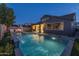 Stunning backyard with a sparkling pool, fire pit, and outdoor kitchen at 10538 E Sheffield Dr, Mesa, AZ 85212