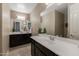 Clean bathroom with dark wood vanity and a large mirror at 10538 E Sheffield Dr, Mesa, AZ 85212