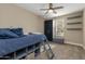 Cozy bedroom with built-in shelving and a comfortable bed at 10538 E Sheffield Dr, Mesa, AZ 85212