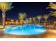 Night view of a resort-style pool with palm trees and lounge chairs at 10538 E Sheffield Dr, Mesa, AZ 85212