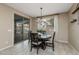 Bright dining room features a dark wood table with seating for four and a view to the backyard at 10538 E Sheffield Dr, Mesa, AZ 85212