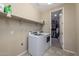 Laundry room with washer, dryer, and access to a large closet at 10538 E Sheffield Dr, Mesa, AZ 85212