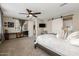 Main bedroom with barn door to bathroom and plenty of natural light at 10538 E Sheffield Dr, Mesa, AZ 85212