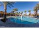 Resort-style pool with plenty of lounge chairs and palm trees at 10538 E Sheffield Dr, Mesa, AZ 85212