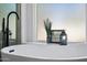 Freestanding bathtub with window and decor at 1082 W Aspen Ave, Gilbert, AZ 85233